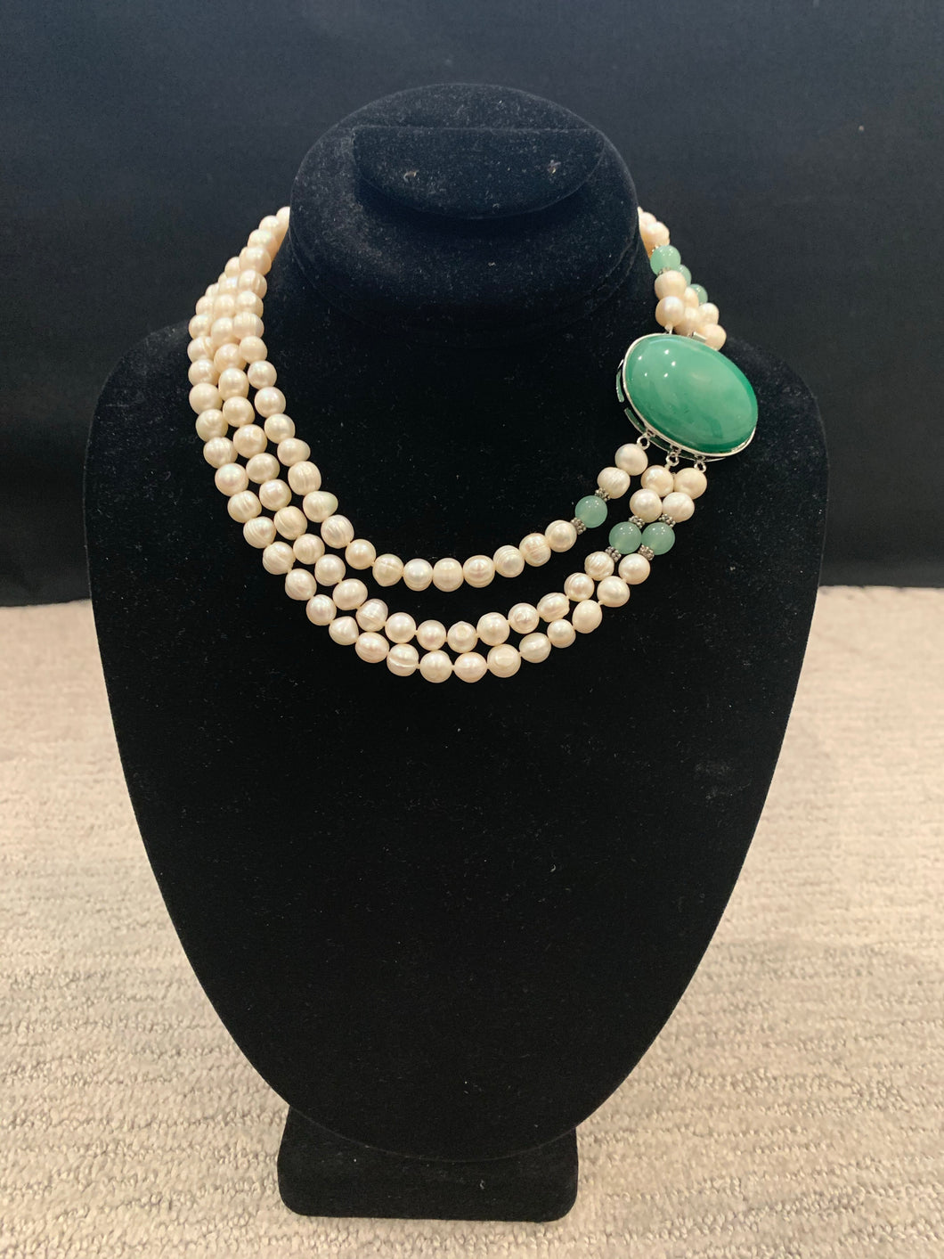 Three strand freshwater pearl with large green stone necklace
