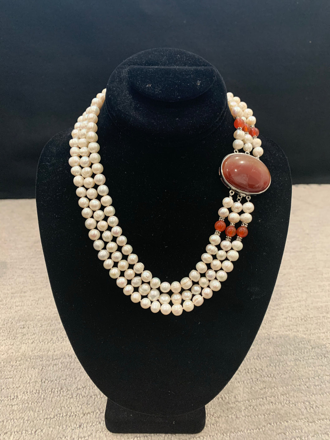 Three strand freshwater pearl with large garnet stone necklace